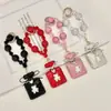 Pingente de chaveiro de garrafa de perfume com laço adornado com diamantes com corrente de contas de cristal, acessório de bolsa requintado e brilhante com diamantes, corrente para pendurar no celular