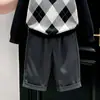 Ropa infantil coreana 2026 colección de otoño nueva: suéter clásico negro con patrón de rombos y cuello, y pantalón de traje gris recto para niños