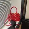 Bolsa de concha com poá estilo coreano transfronteiriça, bolsa de mão color blocking de nicho, bolsa transversal, luxo leve, de alta qualidade, moderna, elegante, bolsa de ombro