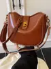 Bolso de Axila de Aspecto Retro de Alta Calidad para Mujer 2025 Nuevo Bolso Cubo Simple Textura de Nicho Hombro Único Cruzado Bolso para Teléfono Móvil
