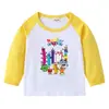 2026 Nova Camiseta Infantil Transfronteiriça Primavera e Outono Gola Redonda Desenho Animado Manga Longa Camisa Básica para Meninos e Meninas Camiseta de Algodão para Bebê