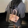 Bolso de mano portátil para verduras de nicho para mujer, primavera 2025, nuevo bolso de mano de moda, bolso tipo cubo con lazo a juego.