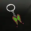 Llavero colgante de aleación de metal con diseño de mariposa Zhilang You Bean de Anime Ghost Extermination Blade que rodea el carbón. Comercio exterior.