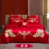 Nuevo conjunto de boda de cuatro piezas 100% algodón bordado 2026, con un diseño lujoso y elegante de algodón de fibra larga, en estilo chino tradicional y color rojo vibrante para bodas