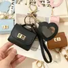 Nueva funda de espejo para auriculares de color sólido en forma de corazón, mini monedero simple, llavero portátil, accesorio de bolso de alta gama