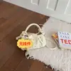 Bolso amarillo nube exquisito súper popular para mujer, nuevo modelo de verano 2026, bolso de mano pequeño cruzado de nicho de lujo ligero de alta gama