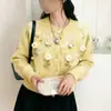 Chaqueta cárdigan suéter de cuello redondo para mujer, nuevo estilo otoño e invierno 2026, con bordado floral tridimensional, top de alta gama estilo francés