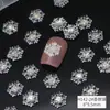 Nuevos adornos para uñas de copo de nieve navideño al por mayor hielo a través de copo de nieve tridimensional pieza blanca fina brillante decoración de uñas de resina