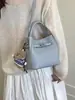 Bolsa de Mão Tipo Balde Simples e Versátil para Mulheres, Nova Moda Primavera 2026, Alta Qualidade, Bolsa de Ombro e Transversal de Luxo Leve