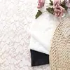 Yuchang primavera y verano nuevo hilo grueso brocado spandex alta elasticidad encaje tela microtransparente patrón de encaje de planta de trébol de cuatro hojas tela