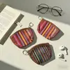 Bolsita pequeña de tela rayada étnica colorida transfronteriza con ribete de imitación de cuero, llavero portátil, bolsa de almacenamiento para auriculares, monedas y tarjetas