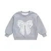 Sudadera para niña de principios de otoño 2026 nueva elegante infantil de primavera moderna versátil conjunto de primavera para bebé con lazo
