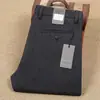 Pantalones casuales de hombre nuevos de sarga de poliéster gruesos cálidos de lana para otoño e invierno alta elasticidad antiarrugas sin planchado