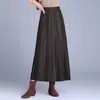 Saia Plissada de Lã Simples na Moda Feminina 2026 Outono/Inverno Novo Estilo Fluida Linha A Barra Larga Midi