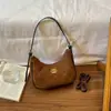 Bolso de mujer de material PU delicado con líneas de cuerpo de bolso lisas diseño de un solo hombro bolso de mano versátil nuevo bolso de un solo hombro
