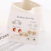 Set creativo de una semana para estudiantes aretes frescos cortos de personalidad aretes decorativos de personalidad femenina aretes pequeños en caja