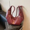 Bolsa de ombro minimalista transfronteiriça em couro macio, bolsa de axila de nicho, bolsa relaxada em formato de meia-lua, bolsa Hobo casual para o dia a dia, bolsa de bolinho