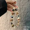 Corrente de Celular com Bolinha de Pelo Estampada de Leopardo Pequena Fragrância Fashion Curta Outono e Inverno Bolinha de Pelo Cristal Pendente Cordão de Pulso para Celular Venda por Atacado