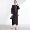 Traje Issey Miyake para estilizar y favorecer la figura tipo pera, conjunto elegante de dos piezas con top holgado de manga larga y cuello redondo y falda de cintura alta