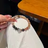 Nuevo brazalete de cristal negro y dorado estilo chino con cuentas de madera de agar y pequeños accesorios de flor, joyería de diseño original para mujer