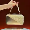 Nuevo bolso de mano para mujer, un clutch sofisticado con un toque de alta gama, versátil y exquisito, con una cadena de cuentas, un bolso de noche a la moda y un bolso cruzado para ocasiones formales
