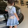 Nova bolsa de mão infantil mini transfronteiriça 2026 versão coreana acabamento em renda laço bolsa transversal infantil pai-filho