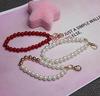 Acessórios de pulseira de pérola feitos à mão versão japonesa e coreana de chaveiro de pulseira DIY feminino pulseira de pérolas feitas à mão para celular DIY liga atacado