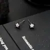 Brincos Cluster de Diamante Cheio de Novo Estilo Transfronteiriços para Homens, Modernos e Versáteis, Brincos de Flor de Íris em Forma de Cruz de Alto Padrão para Mulheres