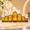 El fabricante de origen proporciona suministro en stock de botellas ámbar de 5-100 ml para aceites esenciales, frascos goteros marrones y botellas ámbar a prueba de luz para aceites esenciales