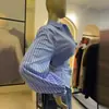 Ropa de mujer transfronteriza europea y americana 2026 otoño nuevo diseño elegante y juvenil camisa de manga larga a rayas con cuello camisero