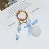 Nuevo Llavero de Pompón de Piel Sintética de Conejo Nudo de Lazo de Perlas Hecho a Mano Adorno Colgante Estilo Ins Empaque de Bolsa Colgante Decorativo Venta al por Mayor