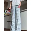 Jeans negros de estilo American high street con rotos y salpicaduras de pintura para hombre, pantalones rectos versátiles de corte holgado, de tendencia para el verano