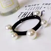 Celebridade da internet 6 elásticos de cabelo com pérolas alta elasticidade linha plana Corda Black Tie elástico de borracha sem costura Joias por atacado de 2 yuans