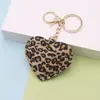 Chaveiro de Couro Sintético com Estampa de Leopardo e Coração para Casal Europeu e Americano Novo, Pingente de Coração de Pêssego para Carro, Pingente para Bolsa, Acessórios, Venda por Atacado