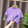 Camiseta de manga larga de algodón puro para niño 2026 primavera y otoño nueva elegante de dibujos animados estilo dos piezas falsas camiseta base de primavera para niño