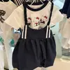 Traje de verano para niñas 2025 nuevo estilo extranjero estampado de dibujos animados para niños camiseta de manga corta tirantes chaleco falda conjunto de dos piezas