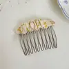 2026 Primavera/Verano Nuevo Estilo de Alta Gama Peine Versátil Simple Pinza Lateral para el Cabello Peine Inverso Dulce Floral Accesorio para el Cabello