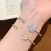 Popular en Xiaohongshu: Pulsera de camelia con circonita de diamante completo ultra brillante para mujer, de alta gama, elegante, versátil, anillo ajustable