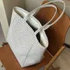 Bolsa de lona listrada estilo coreano de alto valor para mulheres 2025 nova de grande capacidade portátil para carregar na mão bolsa tote para o dia a dia bolsa de compras