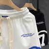 Verano 2023 nuevos shorts blancos estampados marca de moda para hombre pantalones deportivos holgados de cinco puntos pantalones de viaje para hombre Pantalones de playa