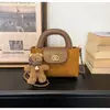 Bolso de mano de alta gama para comercio exterior, nuevo bolso cubo retro de nicho estilo coreano, elegante bolso de hombro, moderno bolso cruzado