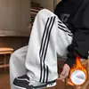 Pantalones a rayas versátiles de moda para hombre, venta al por mayor de fábrica, nuevos pantalones casuales para deportes al aire libre de moda de otoño