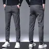 Hong Kong 2026 Outono/Inverno Calças Casuais Masculinas Espessadas com Veludo Plus Calças Longas Versáteis para Negócios Calças de Terno Estilo Coreano Slim Fit Masculinas