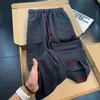 Calça casual de blocos de cor texturizada estilo americano para homens, fina para o outono, com múltiplos bolsos, respirável, perna reta, solta, perna larga