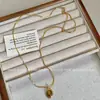 Collar estilo Maillard de piedra Ojo de Tigre ovalado cadena de suéter de Ámbar simple lujo ligero otoño e invierno Nuevo collar para mujer