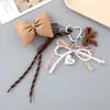 Colgante Creativo Nuevo de Perla de Amor con Lazo para Colgar en Bolso de Cuerda Tejida Miu Colgantes para Teléfono Móvil