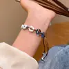 Pulsera trenzada con botón de estrella de mar azul claro y tablero de ajedrez 2025 Nuevo estilo festivo Joyería pequeña y fresca para la playa