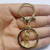 Atacado de fábrica fivela lagosta liga de zinco dourado claro conjunto de três peças com corrente chaveiro de metal com fivela de 8 palavras Pingente de joia