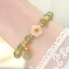 Paso a paso imitación de flor jade Hetian pequeño colgante pulsera de orquídea de lujo ligero diseño de nicho de lujo regalo para novia