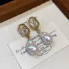 Pendientes de botón de plata con baño de oro real de 18 quilates, con aguja de plata, circonita y diseño único de oreja de gato, de lujo ligero y sensación de alta gama, al por mayor